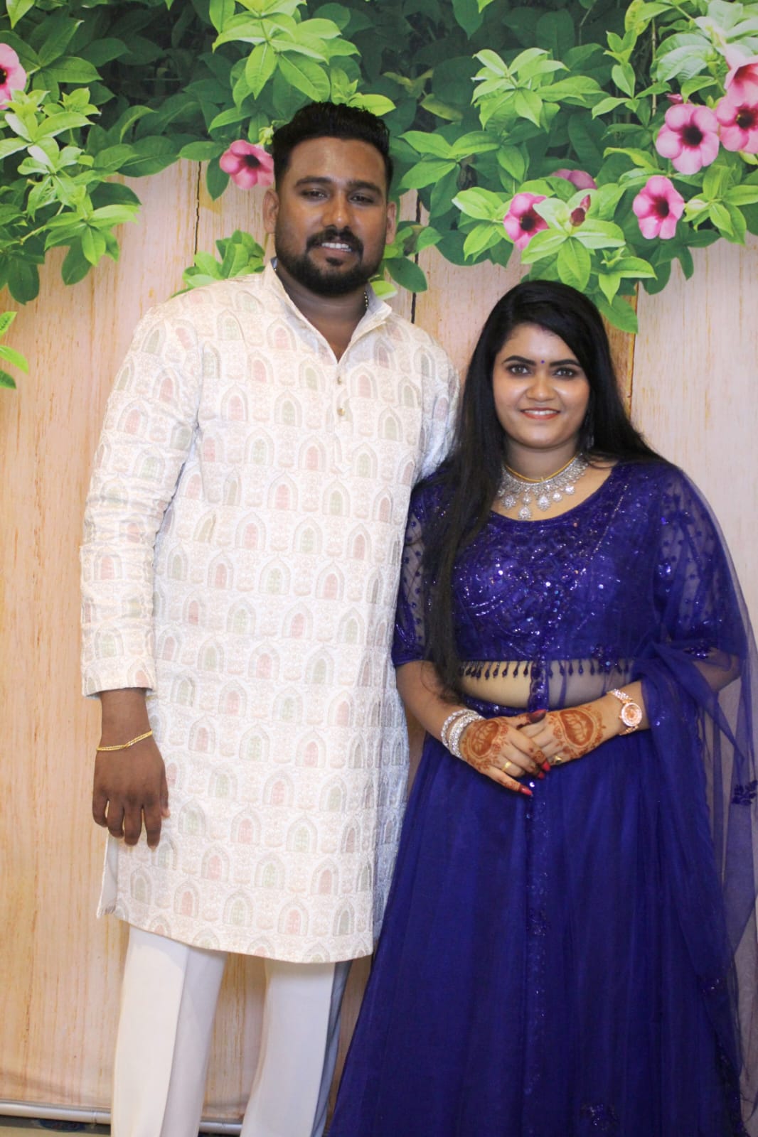 Arjun and Adharvaa posing at their wedding reception photobooth in Nilambur, Kerala