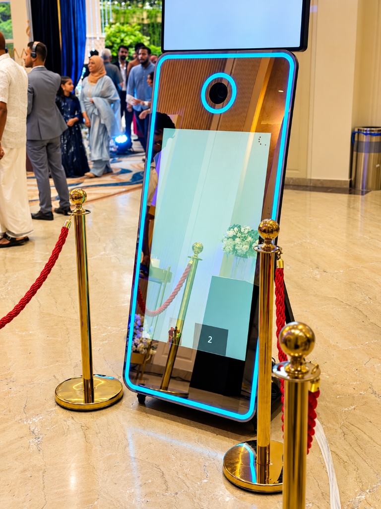 PartyBooth Magic Mirror Photobooth with cyan neon border and red stanchion ropes at Khayal Palace Convention Centre, Mankada