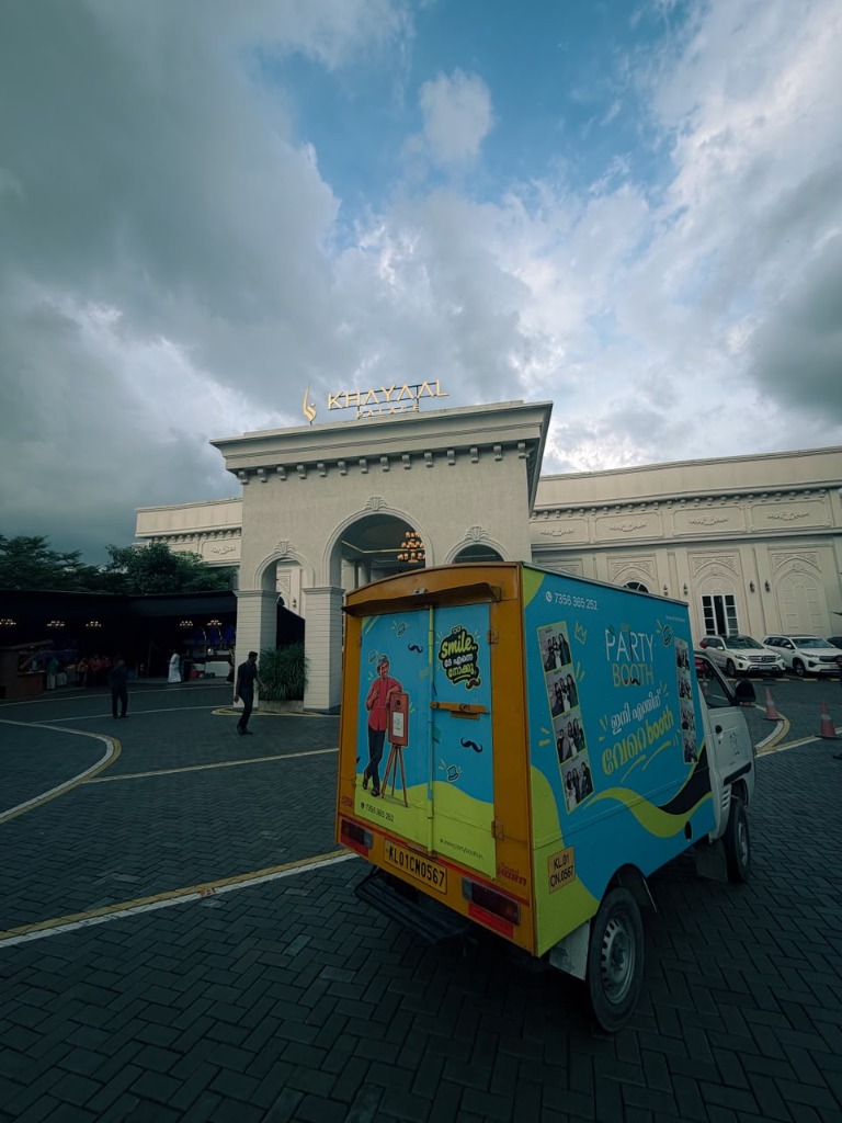 PartyBooth India branded delivery van parked outside Khayal Palace Convention Centre in Karimala, Mankada, Kerala